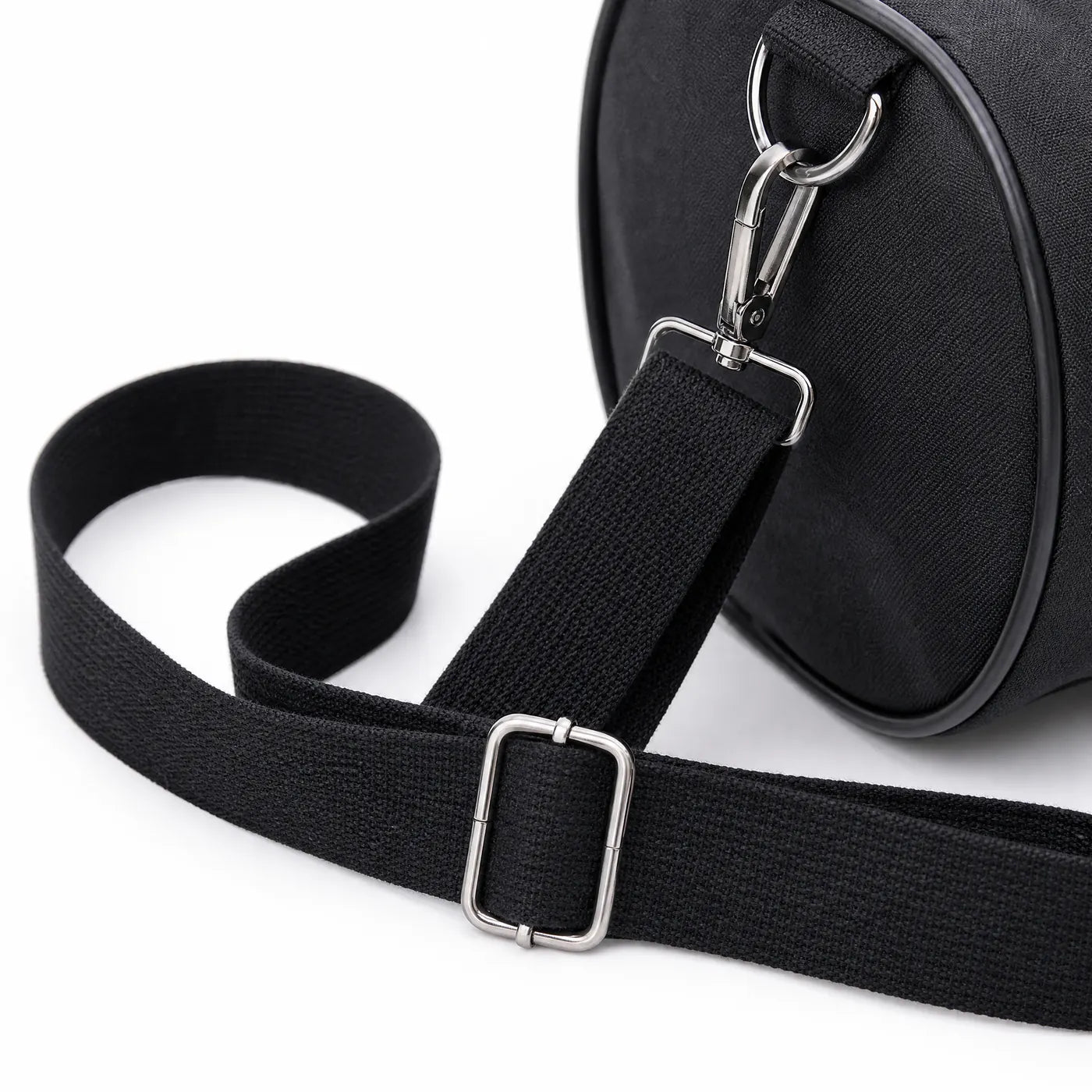 Close view of the adjustable shoulder strap and its metal slider and clip